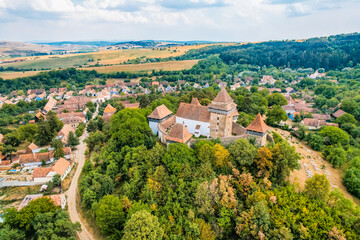 Viscri, Romania. Blue old painted traditional house from village, Transylvania. The Viscri fortified church
