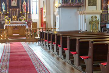 The interior of the church. The altar inside the Catholic church. Icons on the white walls. Places...