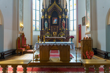 The interior of the church. The altar inside the Catholic church. Icons on the white walls. Places...