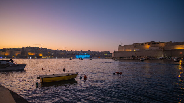 Sunset night scene in a beautiful skyline of the coastal shore of Velletta harbour in Malta Island, Mediterranean Sea