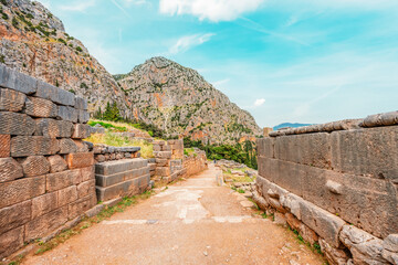 Delphi with ruins of the Temple of the ancient Sanctuary of Apollo in Delphi, Greece, at the Mount Parnassus