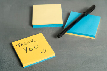 Handwritten message on yellow paper saying thank you