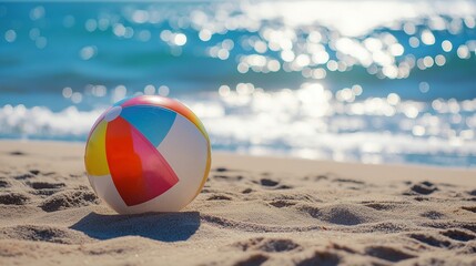 Obraz premium multicolored beach ball bouncing on the sandy beach