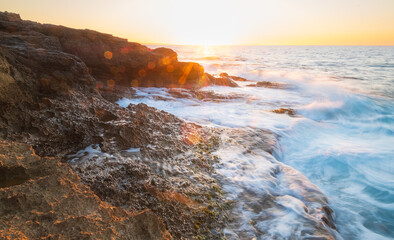 Sunset on the coast of Crete Island. Sunny summer day in Greece photo.