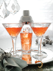 Orange martinis on silver serving tray