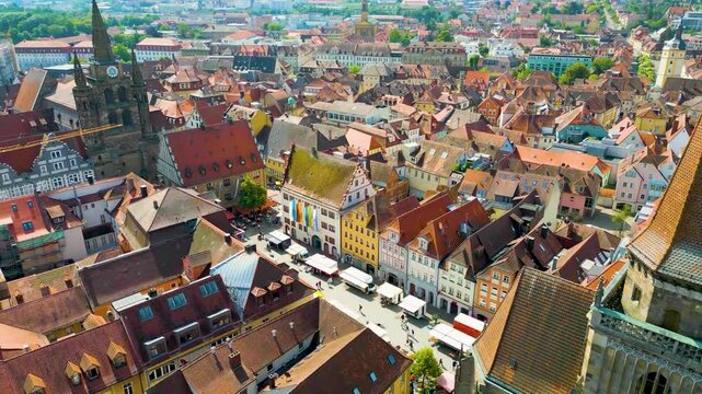 4K Aerial Drone Video of Farmers Market in the Courtyard between the St. Johannis Kirche Church and Kirche St. Gumbertus Church in Ansbach, Germany