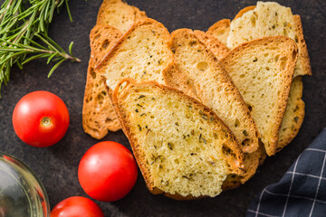 Crispy roasted bruschetta bread on black table.