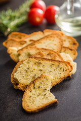 Crispy roasted bruschetta bread on black table.