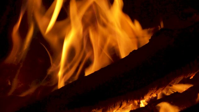 Hot Fire Burning Wooden Logs in Chiminea with Bright Orange Flames in Slow Motion 4K