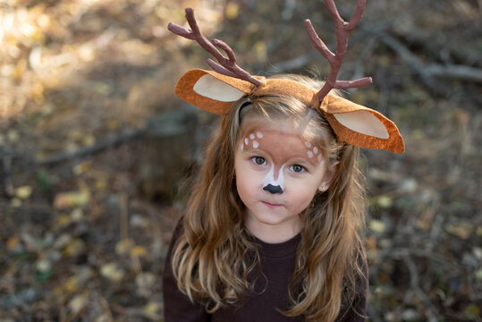 Cute little kid in DIY deer costume dressed up for Halloween