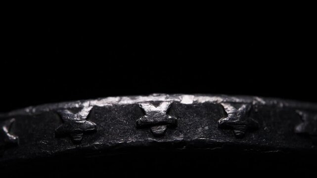 Coin edge, metallic silver star, metal in the darkness, Silver coin in the darkness, slow light movement
