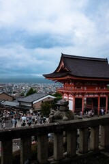 Fototapeta premium Japanese temple in front of buildings on a cloudy day