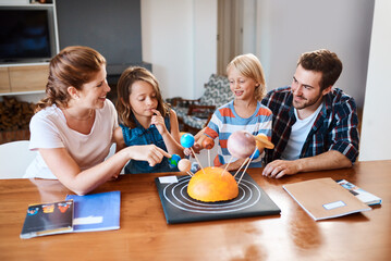 Parents, children and science project for learning in home, building solar system and creativity. Family, support and kindergarten assignment on table, education and teaching knowledge on planets