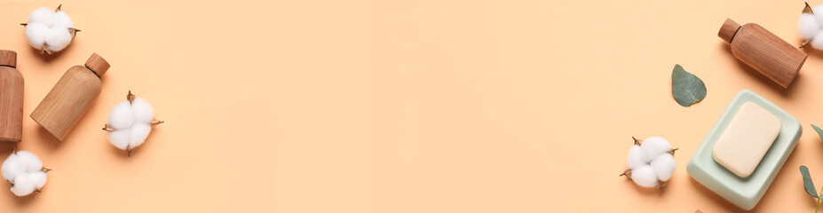 Cosmetic products and cotton flowers on dark beige background, flat lay. Banner design with space for text