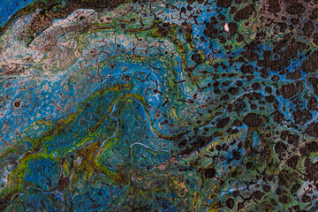 Abstract blue and green pattern with texture resembling marbled surfaces