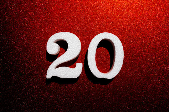 White foam number 20 on sparkling red background