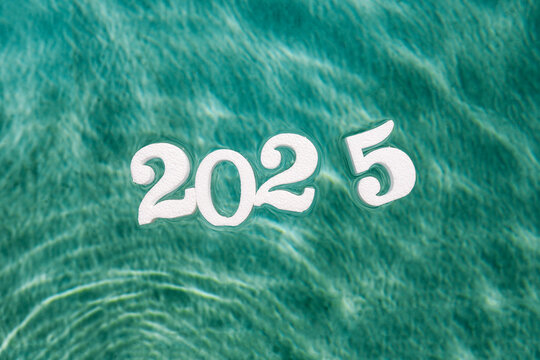 Celebrating the arrival of the New Year 2025 over ocean waves