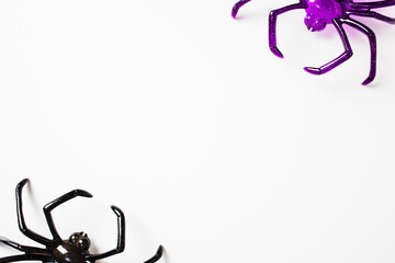 Purple and Black Plastic Spiders on White Background. Perfect for Halloween decorations, spooky themes, or phobia illustrations