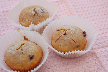 Muffins with cranberry on a pink background. No people.