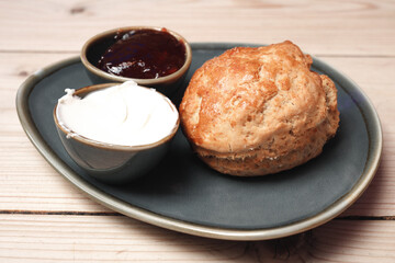 London, UK - September 8, 2024: Closeup of a plain scone with Blueberry jam and clotted cream
