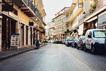 Obraz premium Vintage, street and buildings in city outdoor with architecture, travel path and history tourism of location. Urban, business and storefronts for traditional culture, holiday landmark and destination