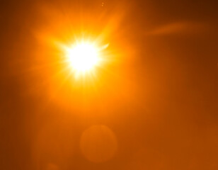 Obraz premium Light over yellow background. Easy to add overlay or screen filter over photos. Abstract golden sun burst with lens flare background. Gleams round and round shapes, orange halo.