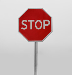Red traffic sign on a post on road isolated on white sky background. stop sign, symbol. simple...