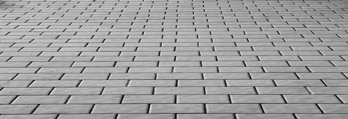 Grey brick paving stone street road. Light sidewalk, pavement texture. Black and White Marble tiled...