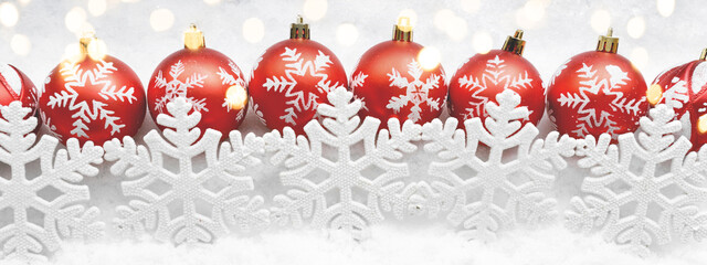 Christmas red balls decorated snowflakes on snow background
