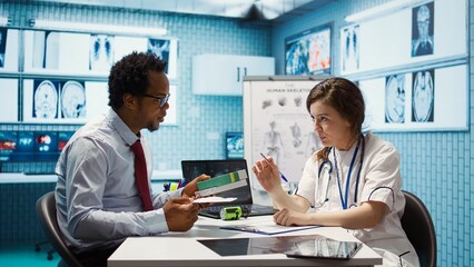 Woman physician offering drugs and painkillers on prescription medicine, recommending the right dosage and giving instructions to help relieve pain. Medicare insurance healthcare industry. Camera B.