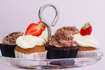 Candy bar at celebration party. Close up of sweets, cakes, pastries, muffins with strawberries.