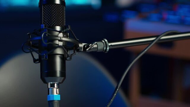 Close up shot of podcast microphone used to record internet show for online livestreaming channel. Streaming sound capturing and recording podcasting tool in empty living room with neon lights