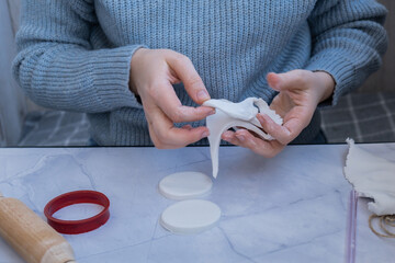 Unrecognizable artist do it yourself air dry clay crafts for Christmas tree decor holiday....