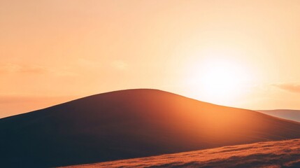 A breathtaking autumn sunset over a hill, showcasing warm tones blending seamlessly in the sky. The vibrant colors of orange, gold, and deep red create a stunning backdrop