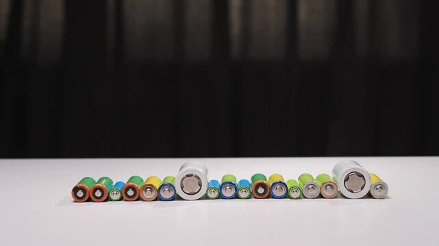Rotating cylindrical batteries displayed in colorful arrangement