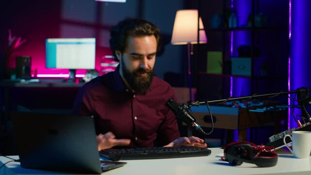 Man in studio reviewing gaming keyboard received from sponsoring brand. Online show host paid to promote bluetooth wireless computer peripheral to viewers during live broadcast, camera A