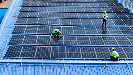 engineer man inspects construction of solar cell panel or photovoltaic cell by electronic device. Industrial Renewable energy of green power. factory worker working on tower roof.