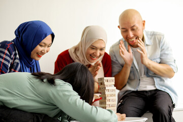 Happy Asian Family Playing Wooden Blocks Tower Together At Home