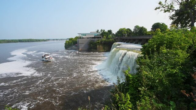 Rideau Falls on a warm summer morning flowing into the Ottawa River with Tavern on the falls in background