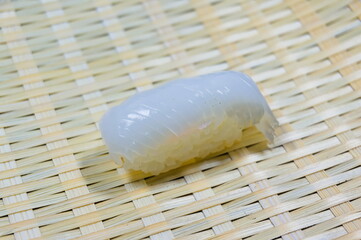 写真に写っているのは、イカのお寿司（squid sushi）一貫です。