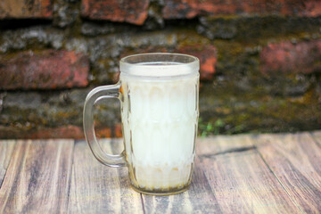 glass of warm cereal milk on a wooden board