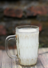 glass of warm cereal milk on a wooden board