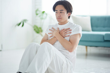 リビングにて腹筋を行う若い日本人の男性