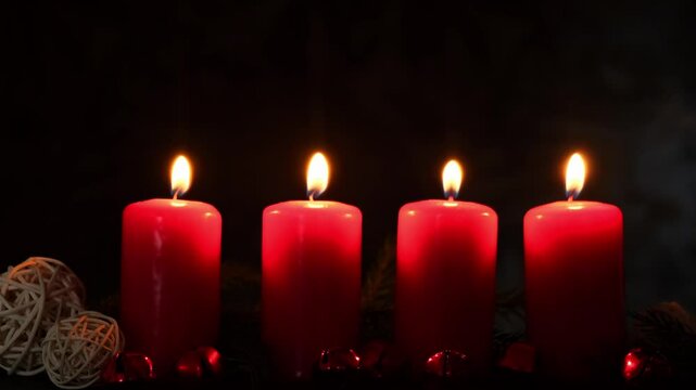 Four Advent red candles burning in dark background, fir branches and Christmas zero waste decorations. Holiday preparation. Catholic traditions of Christmas new year winter holidays 