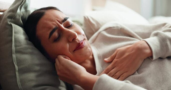 Sleeping, relax and woman on bed, coughing and sick in bedroom, pillow and pain of chest in apartment. Nap, tired and sore throat on mattress, infection and flu in house, allergy or unhappy with cold