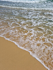 It is a beach with waves crashing in