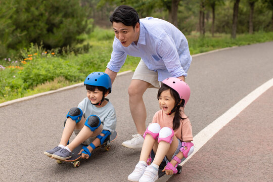 Kids Skateboarding With Dad