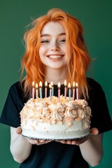 Young woman bright orange hair holding large cake with color