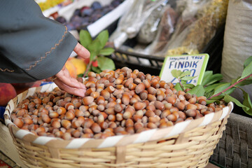 A basket filled with fresh and delicious hazelnuts is beautifully displayed at a local market
