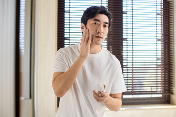 Mature Man Applying Moisturizer